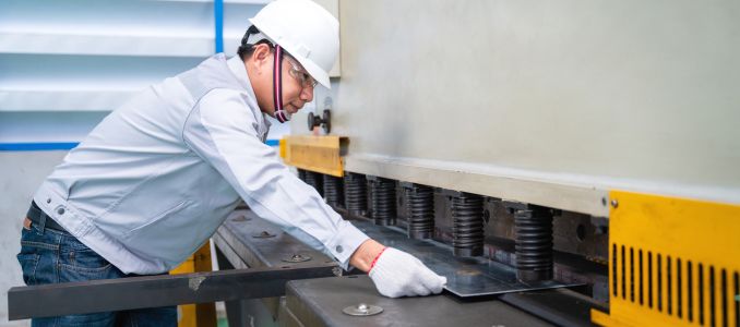 Worker operating sheet metal machine