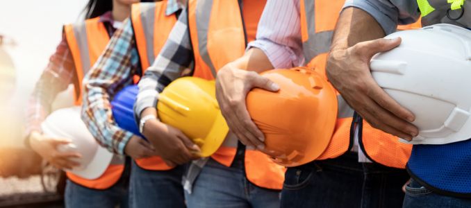 Construction Workers Holding Hard Hats