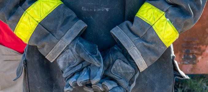 Fire fighter wearing protective gloves