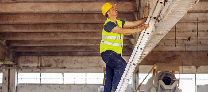 Worker climbing up ladder