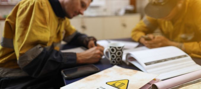 Professionals working on safety documents at desk