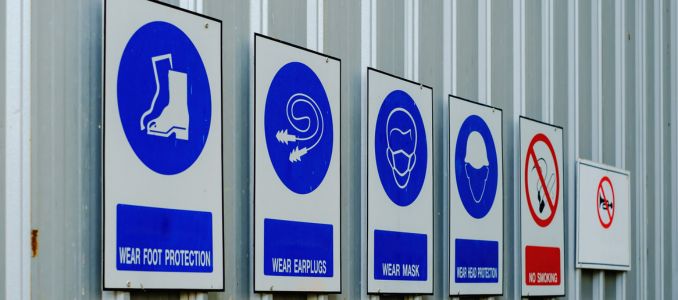 PPE safety signs pinned to wall