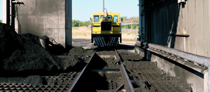 Railway machinery with coal laying on ground