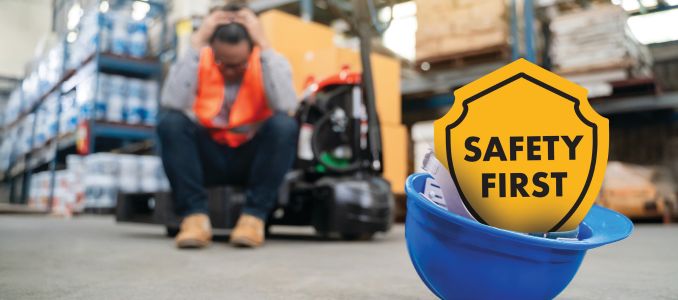 Safety First sign with worker in the background