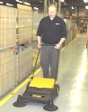 worker sweeping up dust