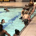 An image of kids swimming in an indoor pool.