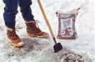 Someone removing ice from a sidewalk