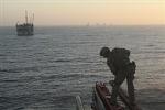 This DoD photo by Lance Cpl. Ryan Carpenter, dated July 10, shows a Marine with the 11th Marine Expeditionary Unit maritime raid force searching an oil platform during the exercise.