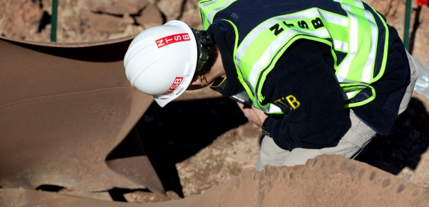 This NTSB photo shows Donald Kramer, an NTSB metallurgist, examining the ruptured segment of pipe in Sissonville, W.Va.