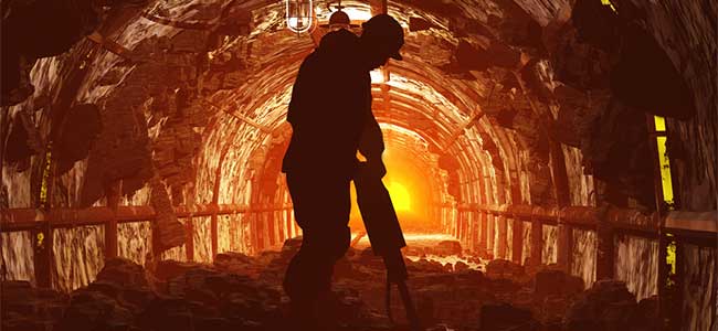 a miner drilling in an underground mine