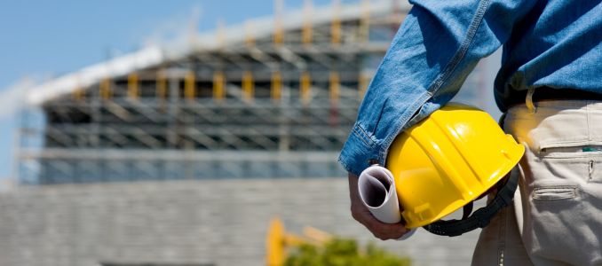 Construction Worker Holding Helmet