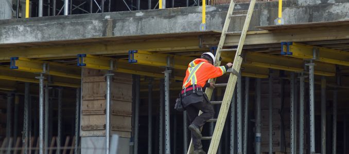 Worker climbing down a ladder