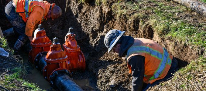 Construction workers in unprotected trench