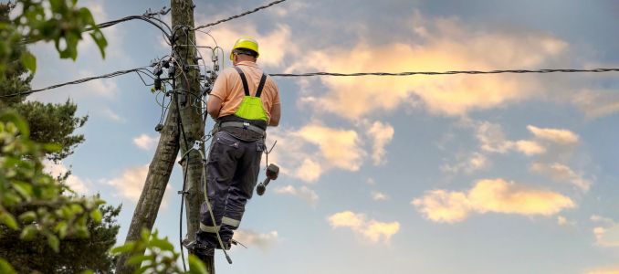 Professional working on utility pole