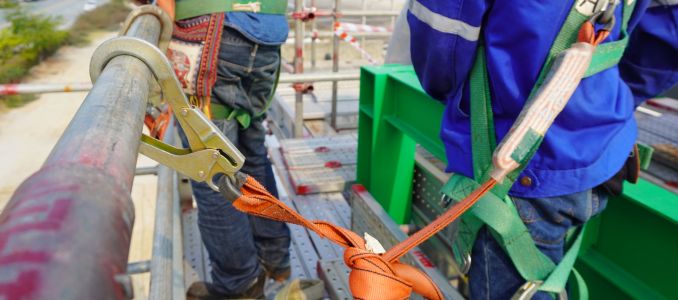 Workers on scaffold using harness 