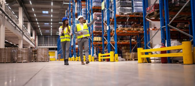Two safety professionals walking in warehouse