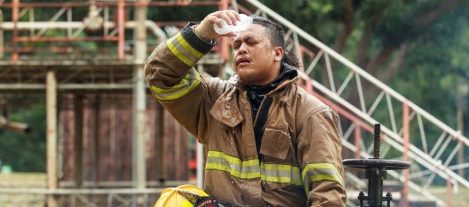 Firefighter cooling down with a bottle of water
