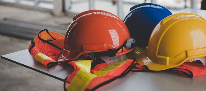 Safety helmets and vest on table