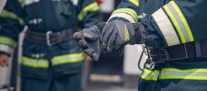 firefighter standing in front of another firefighter