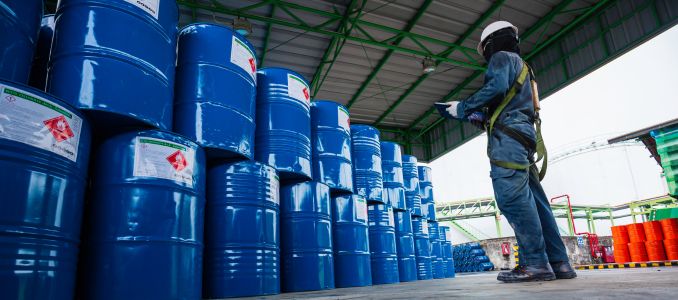 Male worker inspection record drum oil stock barrels blue vertical or chemical