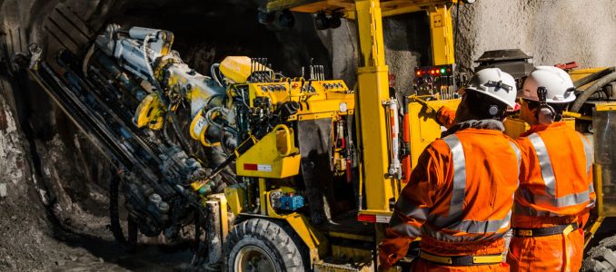 Miners inspecting machinery 