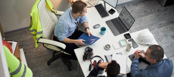 foreman discussing construction project at office desk