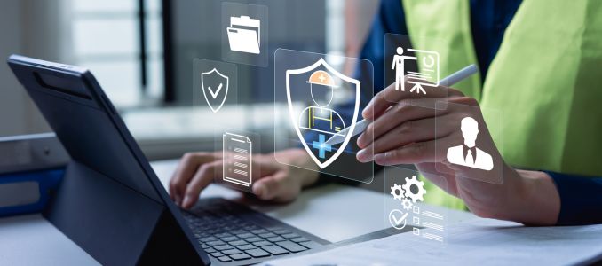 Safety specialist using laptop with digital protection icons, workplace compliance monitoring, risk prevention strategy and occupational health management system concept