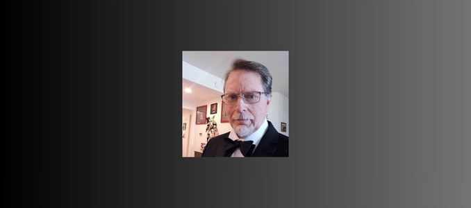 Headshot of James Poage wearing a tuxedo with a black bow tie and glasses.
