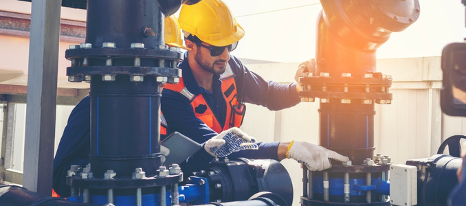 A worker inspects valves and piping at an industrial facility. CSB linked the Shell Polymers Monaca explosion to a valve error and inadequate safeguards.