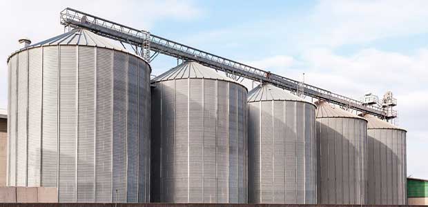 five short, wide, grey silos