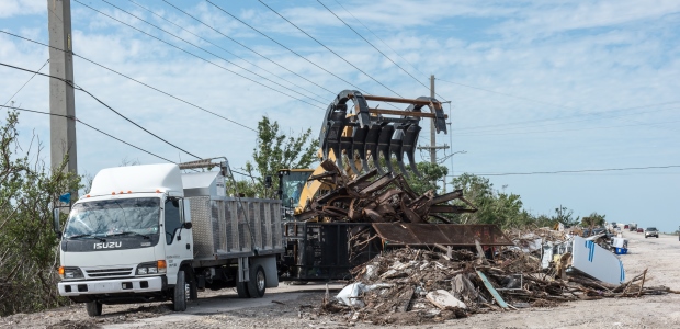 This Nov. 27, 2017, photo from Ramrod Key, Fla., shows contractors using heavy equipment and trucks to haul debris from a highway after Hurricane Irma. (Howard Greenblatt/FEMA photo)