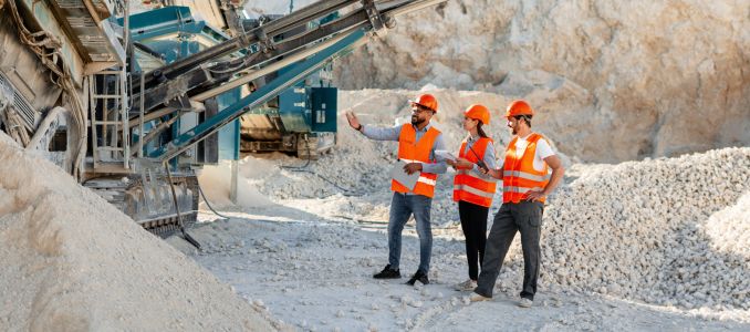 Three workers in PPE doing safety inspection at a mine