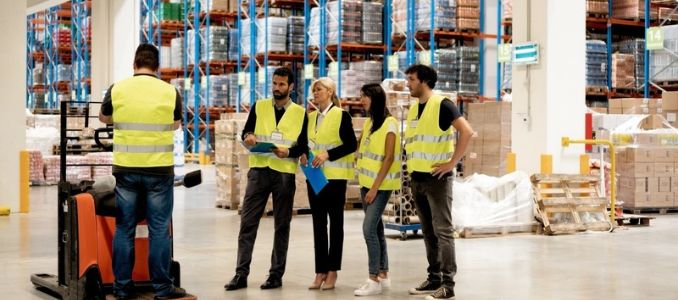 Warehouse professionals receiving forklift training.